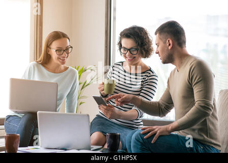 Pleasant smiling colleagues sitting in the office Stock Photo