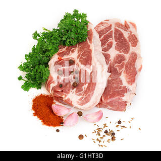 Fresh red meat with spices and parsley close-up on a white background. Stock Photo
