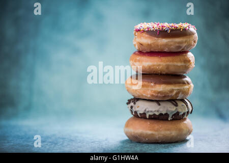 Donuts tower with copy space background, vibrant colors Stock Photo