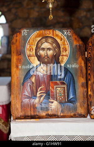 Jesus Christ holding Holy Book. Blessing gesture. church decoration Greece Stock Photo