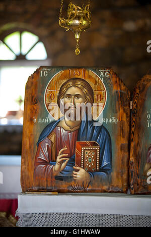 Jesus Christ holding Holy Book. Blessing gesture. church decoration Greece Stock Photo