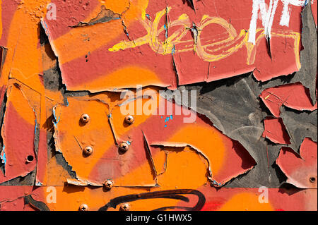 Graffiti and Peeling Paint on Wall Detail Background Stock Photo