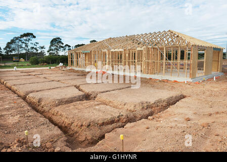 New residential construction home framing against a blue sky. Stock Photo