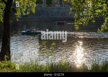 People enjoying a summer day in grass, Strelecky ostrov, Prague, Czech republic Stock Photo