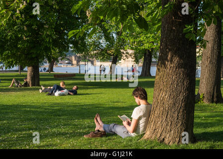 People enjoying a summer day in grass, Strelecky ostrov, Prague, Czech republic Stock Photo