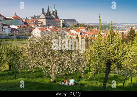 Enjoying of the sun in springtime, Lesser Quarter, Prague, Czech Republic. Background is Prague Castle Stock Photo