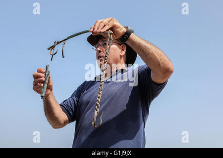 Caesarea, Israel. 16th May, 2016. JACOB SHARVIT, Director of the Marine Archaeology Unit of the Israel Antiquities Authority, holds up an ancient balance scale. An underwater salvage survey conducted in recent weeks at the ancient Caesarea Harbor by divers from the Israel Antiquities Authority has led to the exposure of a “large, spectacular and beautiful, ancient marine cargo” of a merchant ship that sank during the Late Roman period. Credit:  Nir Alon/Alamy Live News Stock Photo