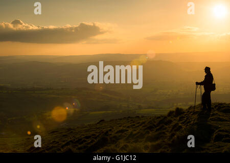 A walker pauses on the Shropshire Way footpath on top of Brown Clee Hill in Shropshire, England, UK. Stock Photo