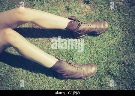 A young woman's legs on the grass on a summer's day Stock Photo