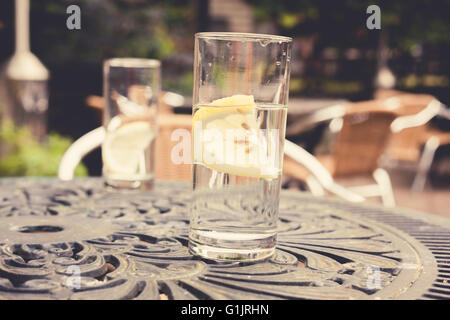 Two glasses with lemon on a table in a garden Stock Photo