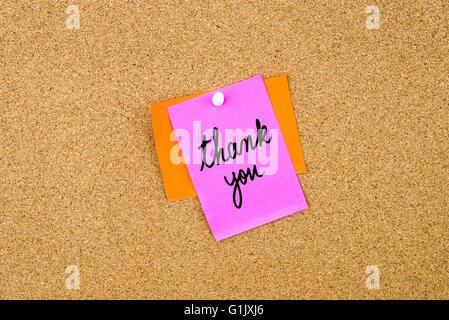 Thank You written on paper note pinned on cork board with white thumbtack, copy space available Stock Photo