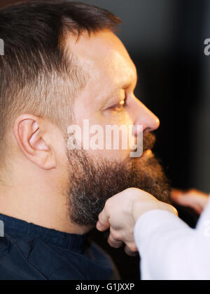 Side view of adult man at barbershop Stock Photo