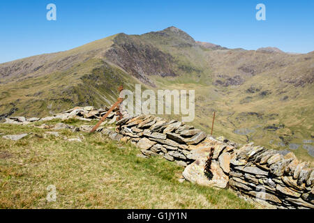 View from Yr Aran across drystone wall and Cwm Llan to Mount Snowdon south ridge and Watkin Path routes in Snowdonia National Park Wales UK Stock Photo