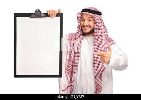 Young joyful Arab holding a clipboard and pointing towards it isolated on white background Stock Photo