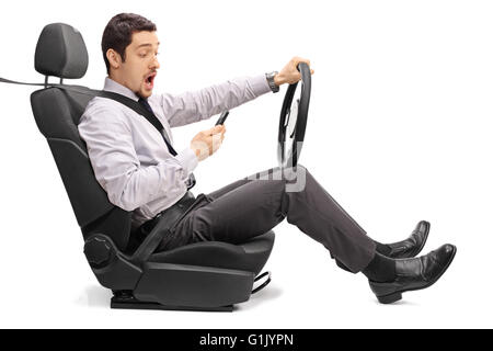Young man driving and reading something on his phone isolated on white background Stock Photo