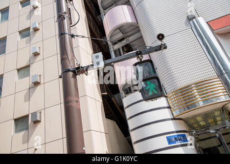 Green walking man on crossing signal in a city Stock Photo