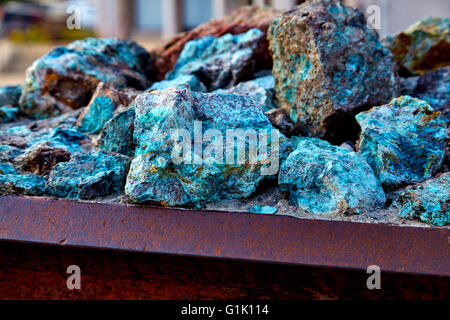 Chunks of copper ore mineral rocks in an iron barrel Stock Photo