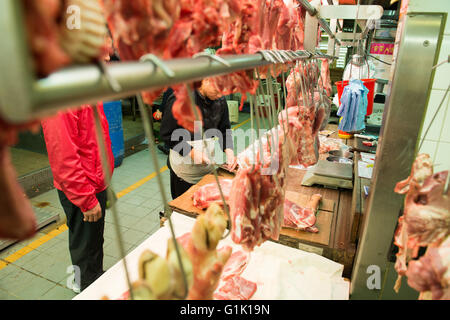 Fresh meat cut and hanging at market butchers in Asia Stock Photo