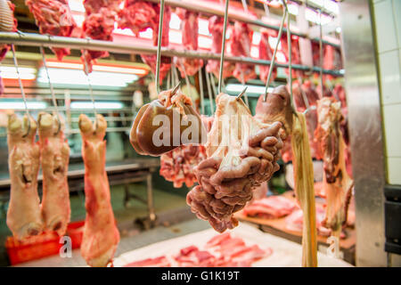 Fresh meat cut and hanging at market butchers in Asia Stock Photo