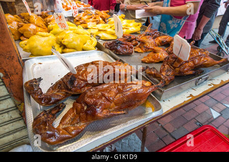 Whole roasted duck on trays at Chinese market Stock Photo