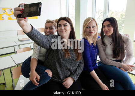 The head-down generation is on working with their smartphone. Stock Photo