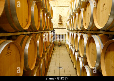 New oak barrels in ageing cellars of Wine Estate Chateau Carignan, Carignan de Bordeaux, France. Stock Photo