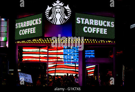 Starbucks coffee shop Times Square with reflection of flag in window Stock Photo