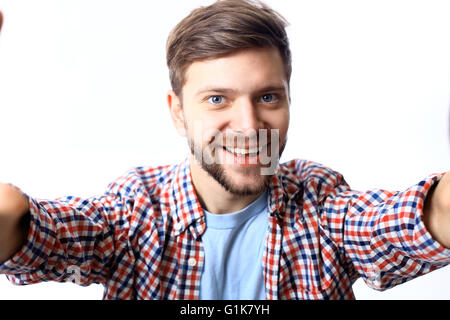 Happy young man taking a selfie photo. Isolated on white Stock Photo