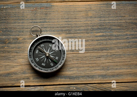 compass on the brown wooden table background Stock Photo