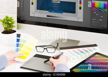 Graphic designer at work. Color swatch samples. Stock Photo
