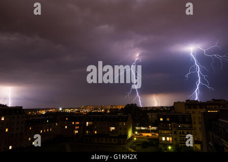 Clouds and thunder lightnings and storm over city. Stock Photo