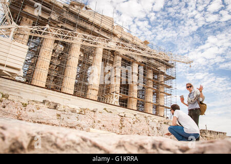 Tourists visit the ancient acropolis hill. Athens, Central Athens. Greece Stock Photo