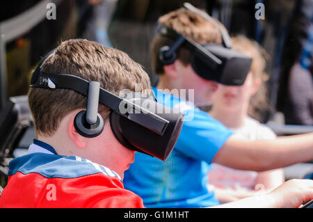 Two boys use Oculus Rifts on a tractor driving simulator Stock Photo