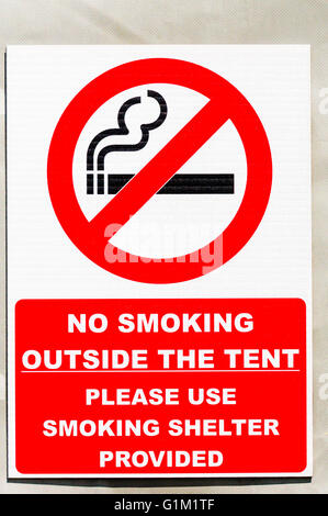 No smoking sign on a tent at a camp site, advising people to use the smoking shelter provided. Stock Photo