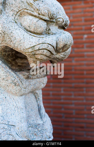 Granite sculpture of traditional chinese lion face close up selective focus Stock Photo