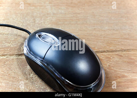 Black wired computer mouse on wood table Stock Photo