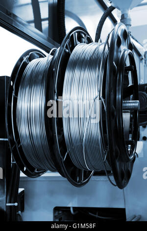 shiny copper wire on spools in the shop Stock Photo