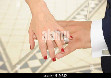 Bride and groom hands with wedding rings Stock Photo