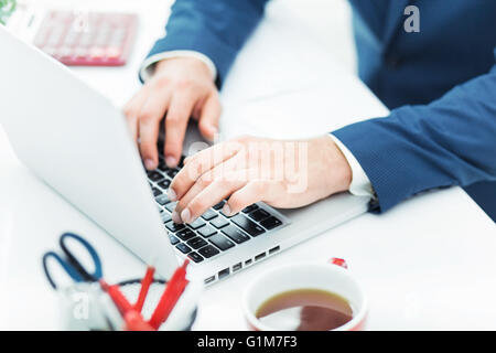 The male hands on the keyboard of laptop computer Stock Photo