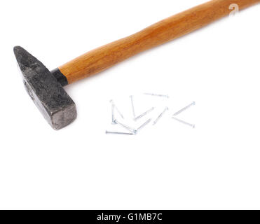 Big hammer with pile of nails over white isolated background Stock Photo