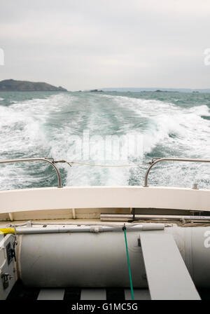 Looking backwards at the wake of a speed boat while it's sailing across the Sea. Stock Photo