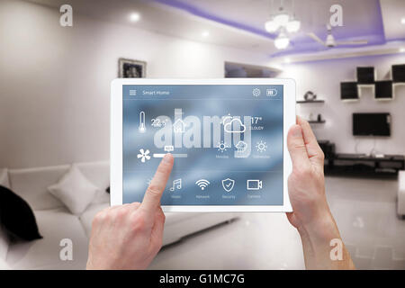 Smart remote home control system app. Living room interior in background. Stock Photo