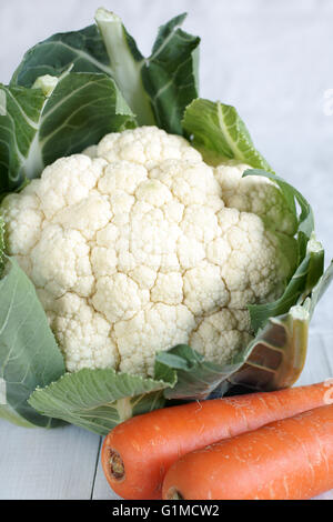 Nice fresh natural cauliflower head with leaves and carrots useful for healthy and organic eating or marketing concepts Stock Photo