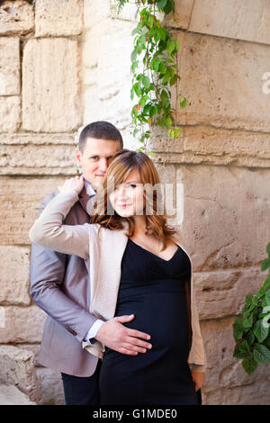 Man tenderly embraced Pregnant Woman Stock Photo