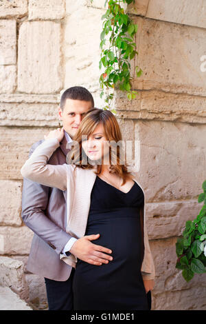 Man tenderly embraced Pregnant Woman Stock Photo