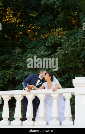 Groom in white shirt kissing bride hand. Very gentle photo Stock Photo