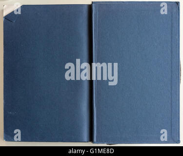 Book opened to the first page showing blank blue pages inside. Stock Photo