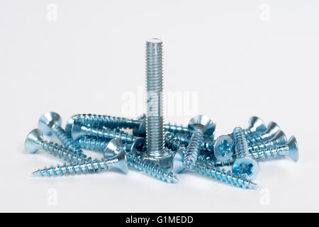 golden and silver screws, bolts on white background Stock Photo