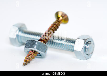 small golden screws, silver bolt and big silver nuts Stock Photo