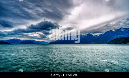Early morning ferry ride from Horseshoe Bay to Sechelt in British Columbia Canada under threatening skies Stock Photo